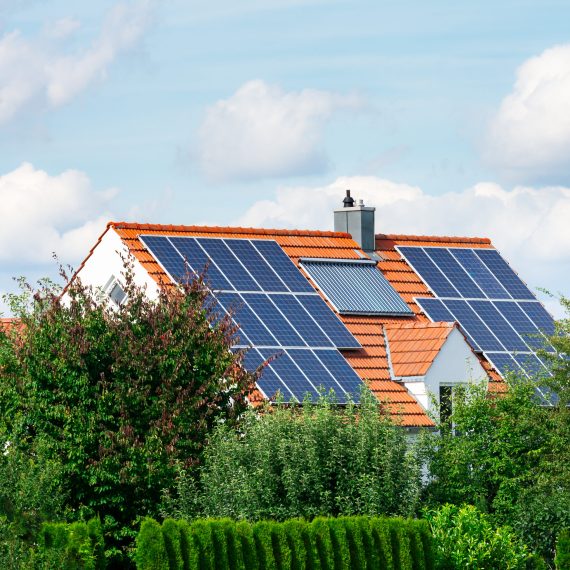 Modern house with photovoltaic solar cells on the roof and a thermal solar heating system for alternative energy production